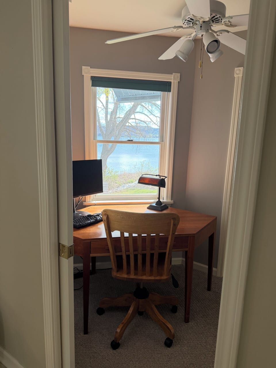 Office with monitor, keyboard, and wi-fi printer.