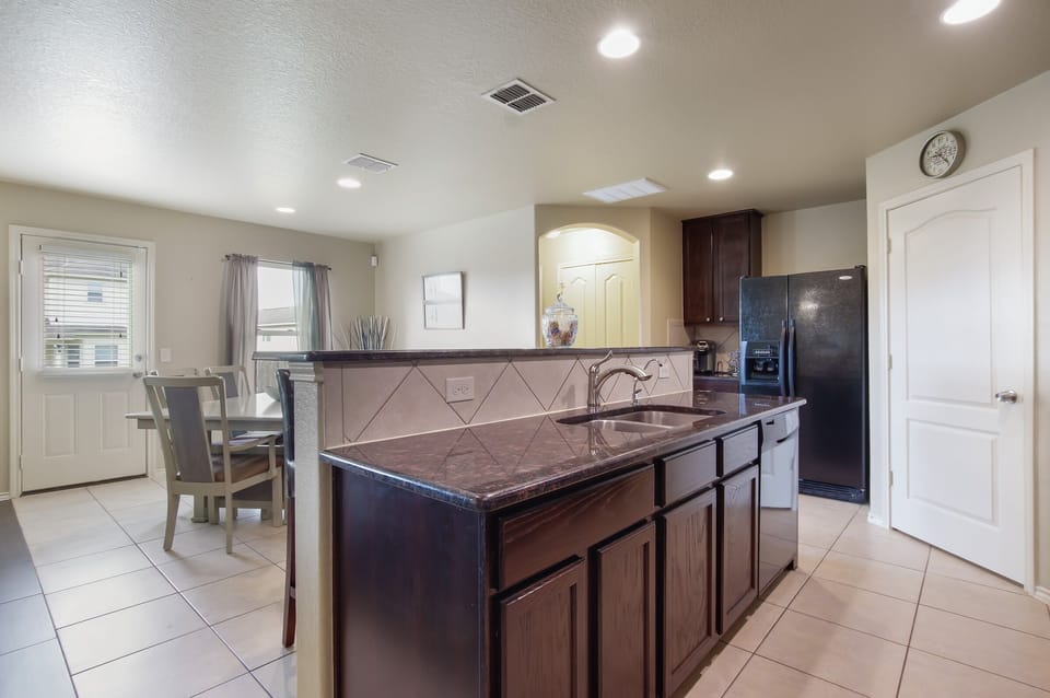 Hard surface counter tops including, dishwasher and full size fridge.