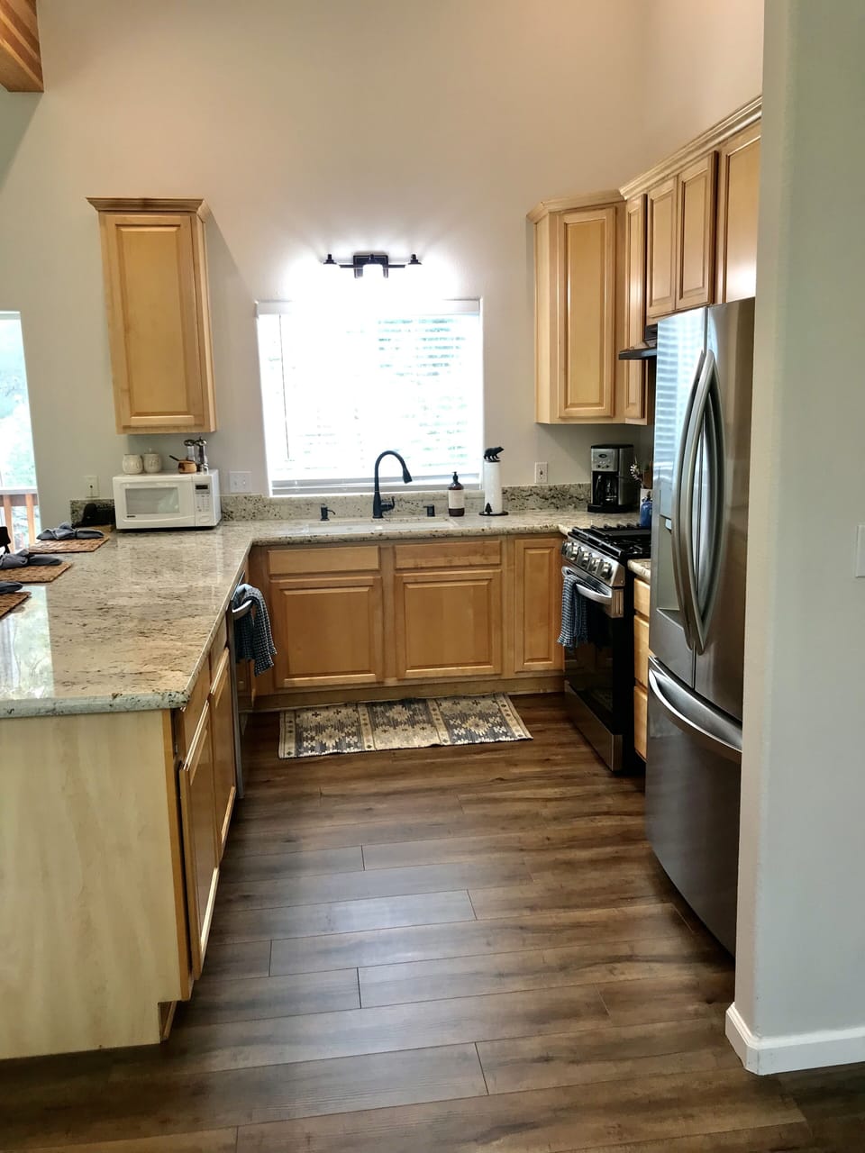 Side view of kitchen with new stainless steel appliances