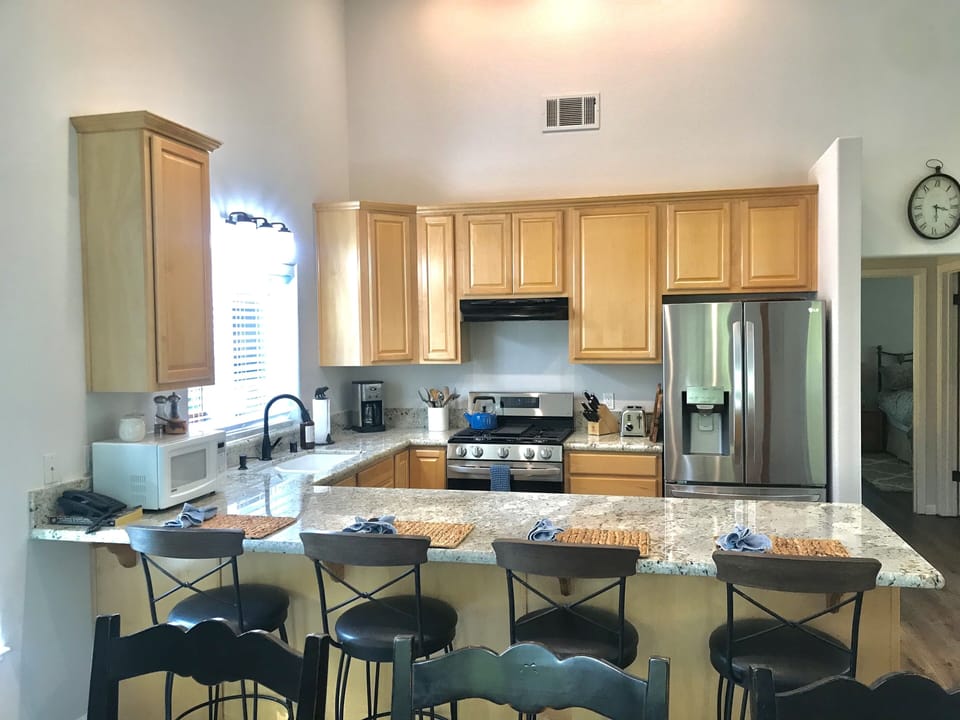Kitchen & hallway leads to guest bath & master bedroom & full bathroom upstairs