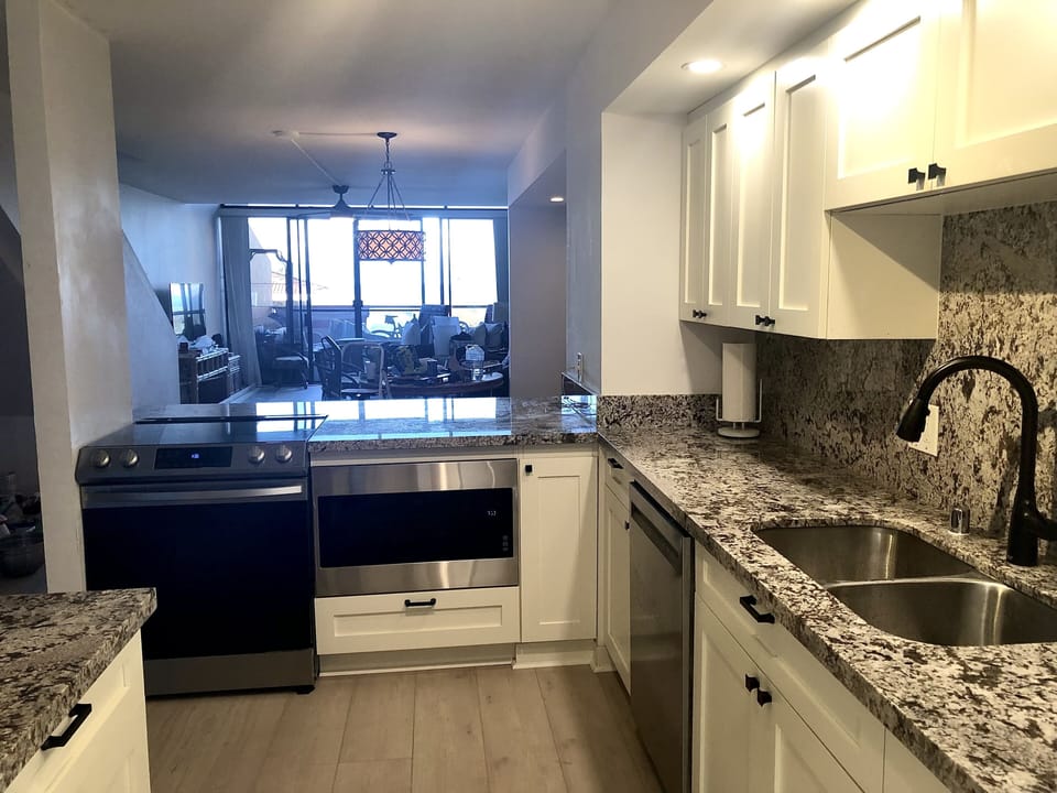Kitchen with open views to living room and ocean.