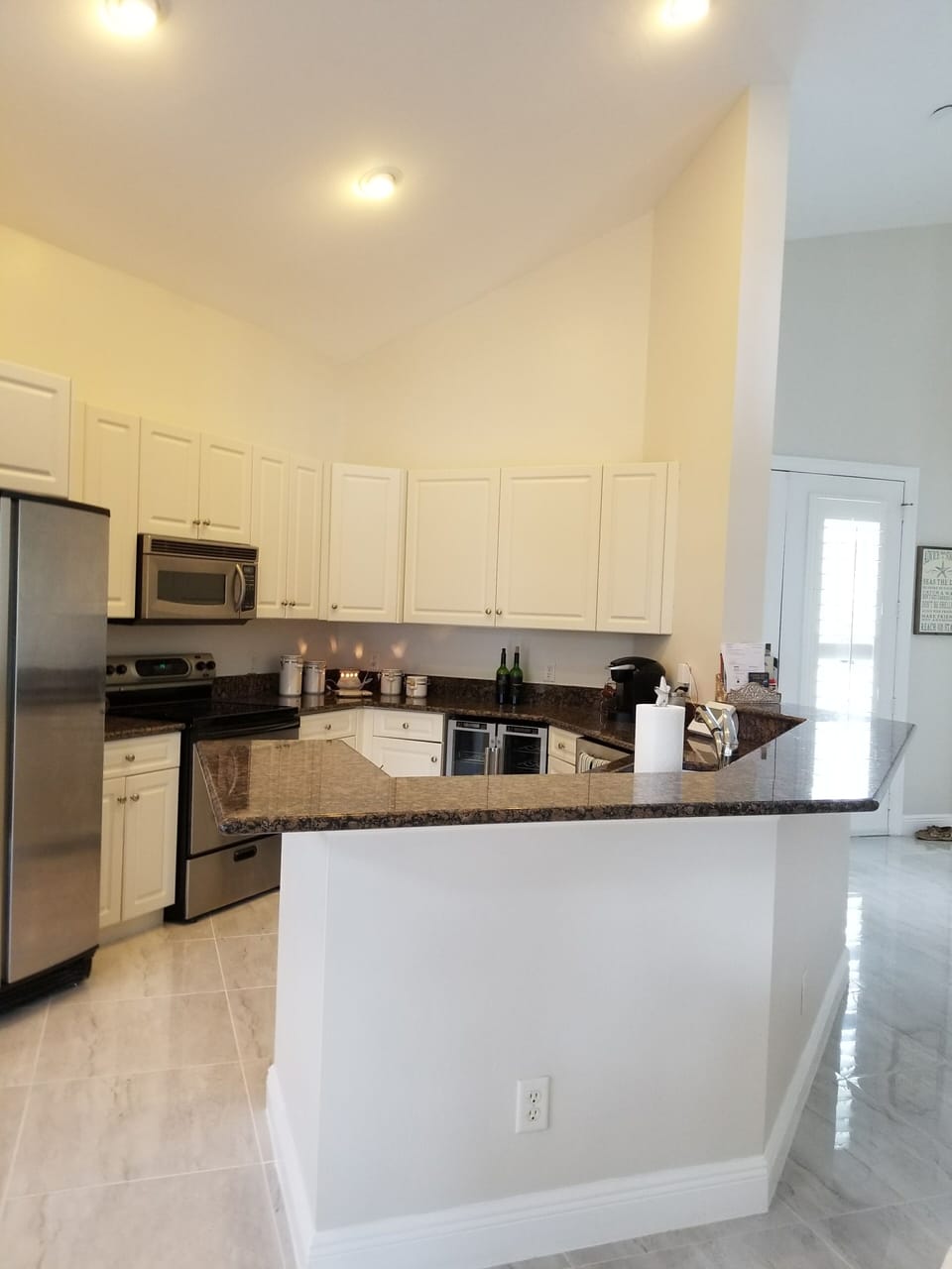 Open kitchen & peninsula with stools makes for easy entertaining.