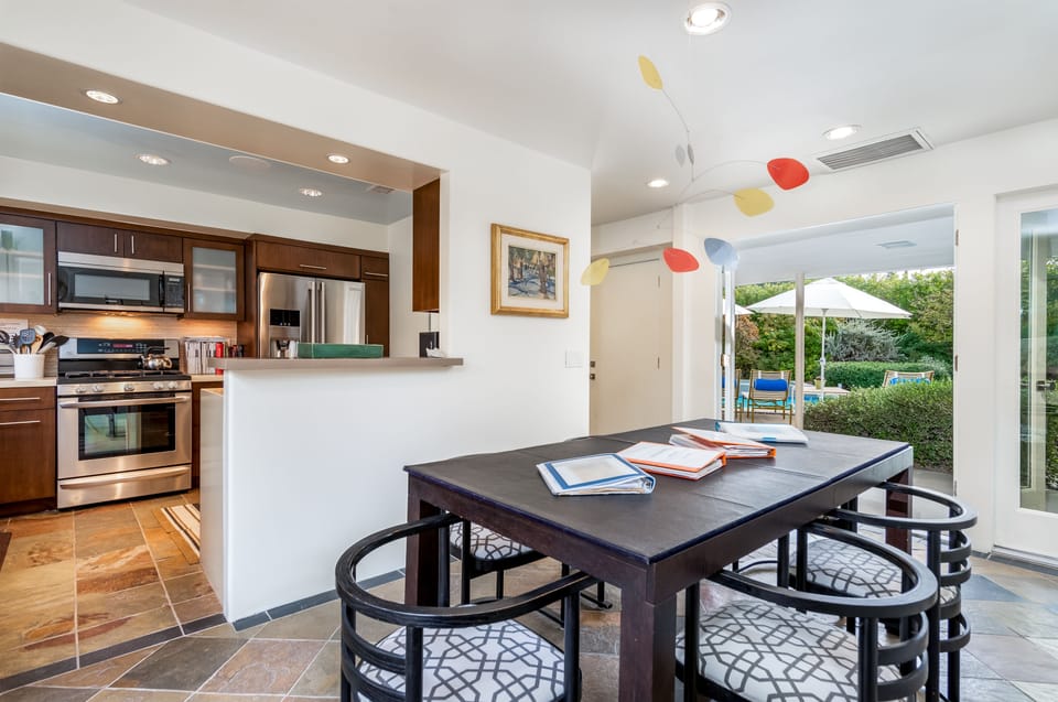 Dining Room with French Doors on both doors to front pool area and back gardens.
