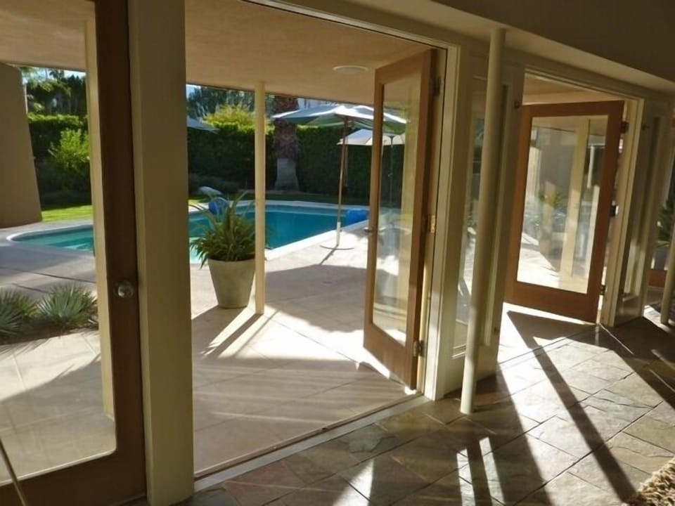 Living Room with French Doors opening out to pool area.  