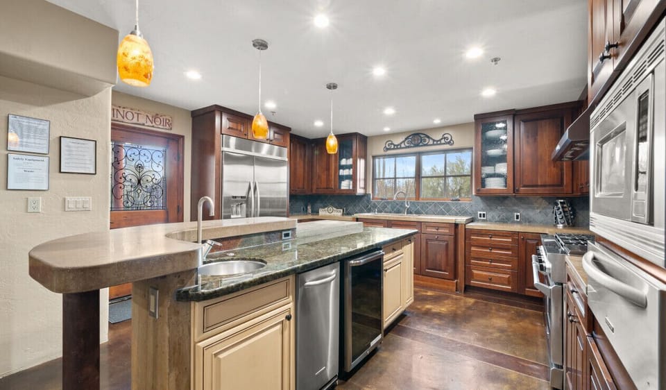[Kitchen] Showing the island with prep sink, mini fridge, dishwasher, and large side by side fridge/freezer