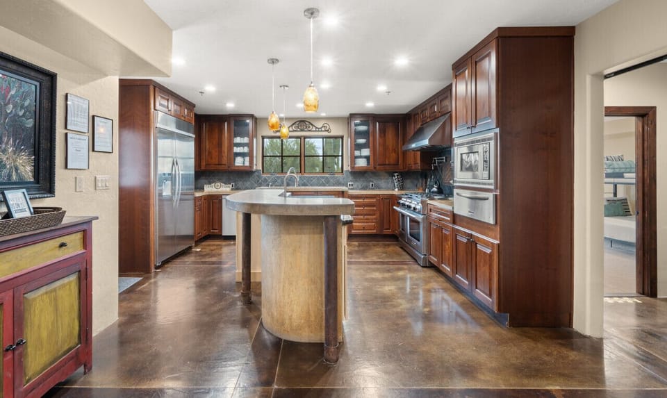 [Kitchen] Well stocked and fully equipped gourmet chef`s kitchen with a 6-burner gas stove, double ovens, large side by side refrigerator/freezer, warming drawer, microwave, & dishwasher