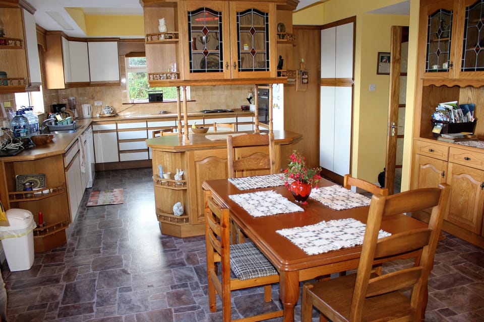 Dinning room with Kitchen. Bright open concept area. Seating for eight or more.