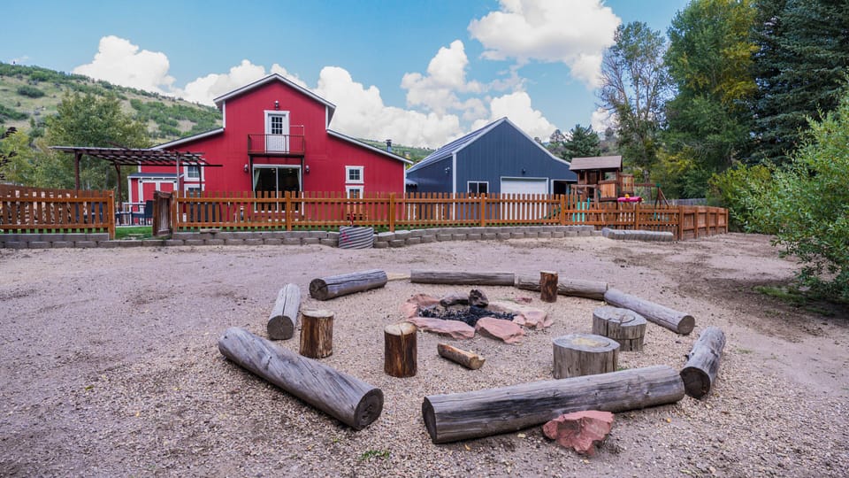 Fire pit outside of fenced back yard by beautiful creek