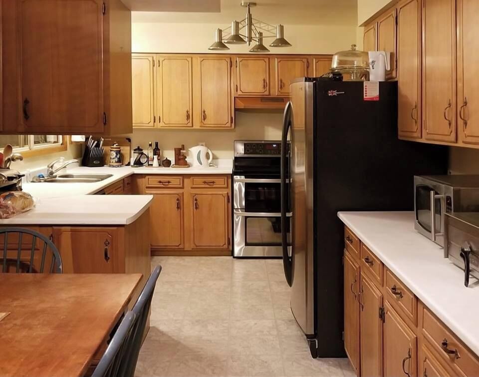 Large kitchen with stainless appliances and double oven