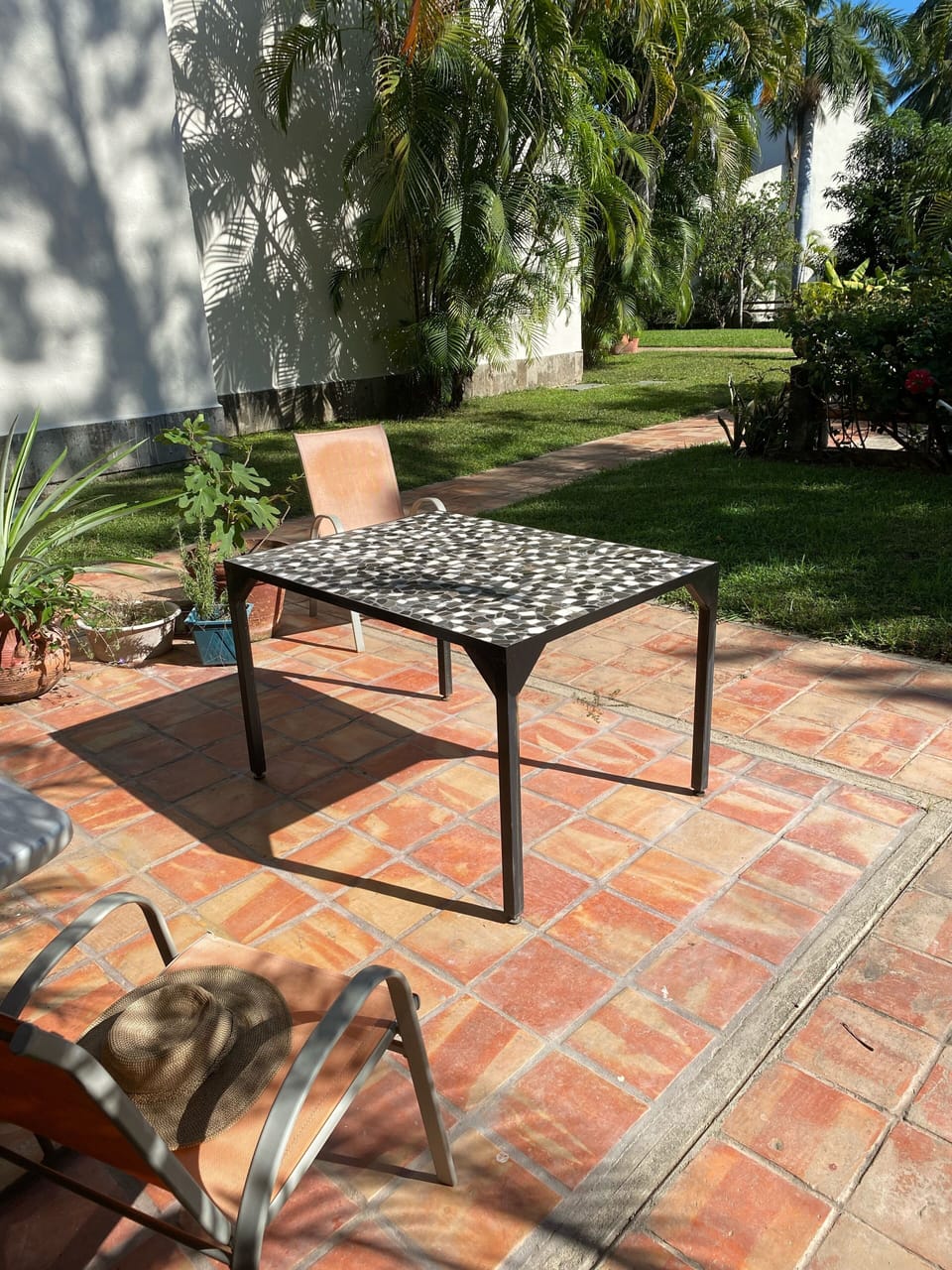 Outdoor table with 6 sling chairs and grill.  