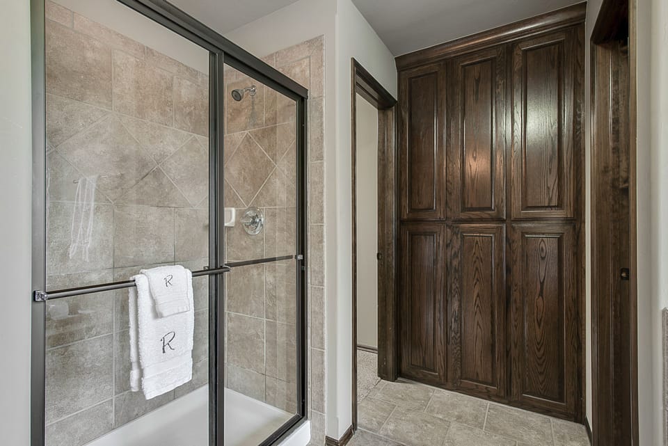 Master bath shower, extra towel storage, master closet