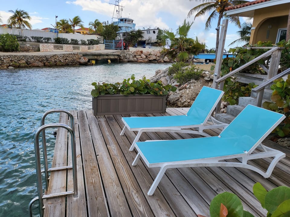 your private deck above the water with sun beds and outside shower