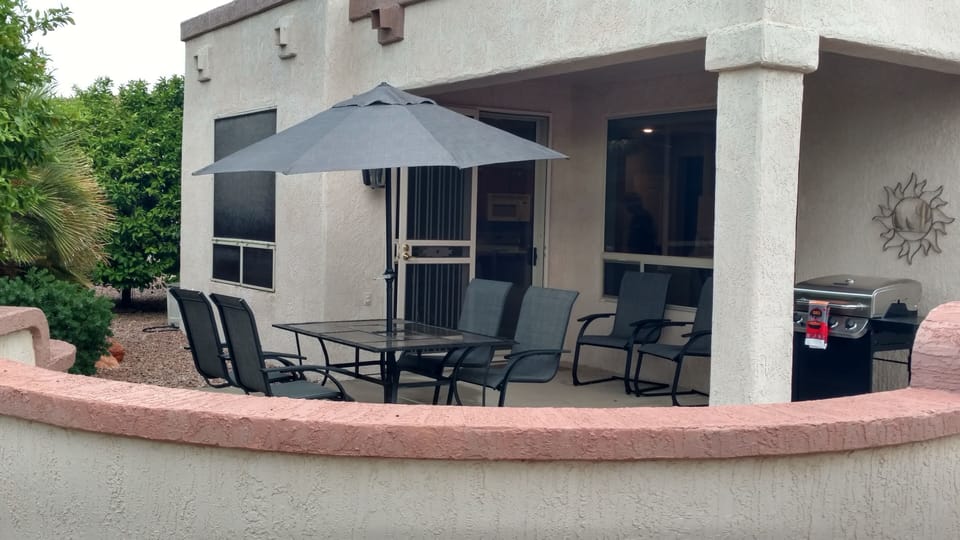 East/southeast facing patio area with dining, grill