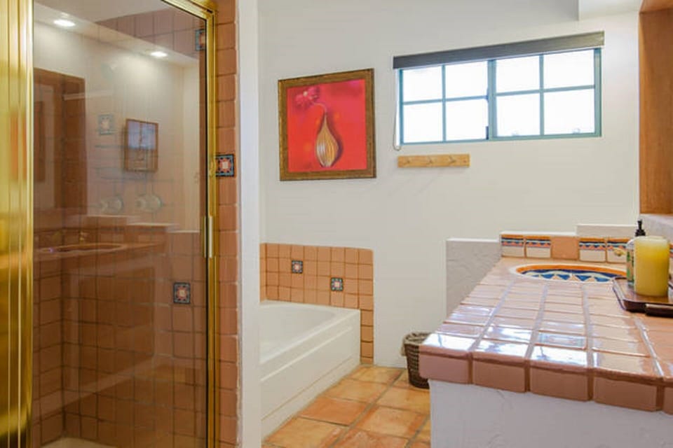Full bathroom with one sink, walk in shower and separate tub.