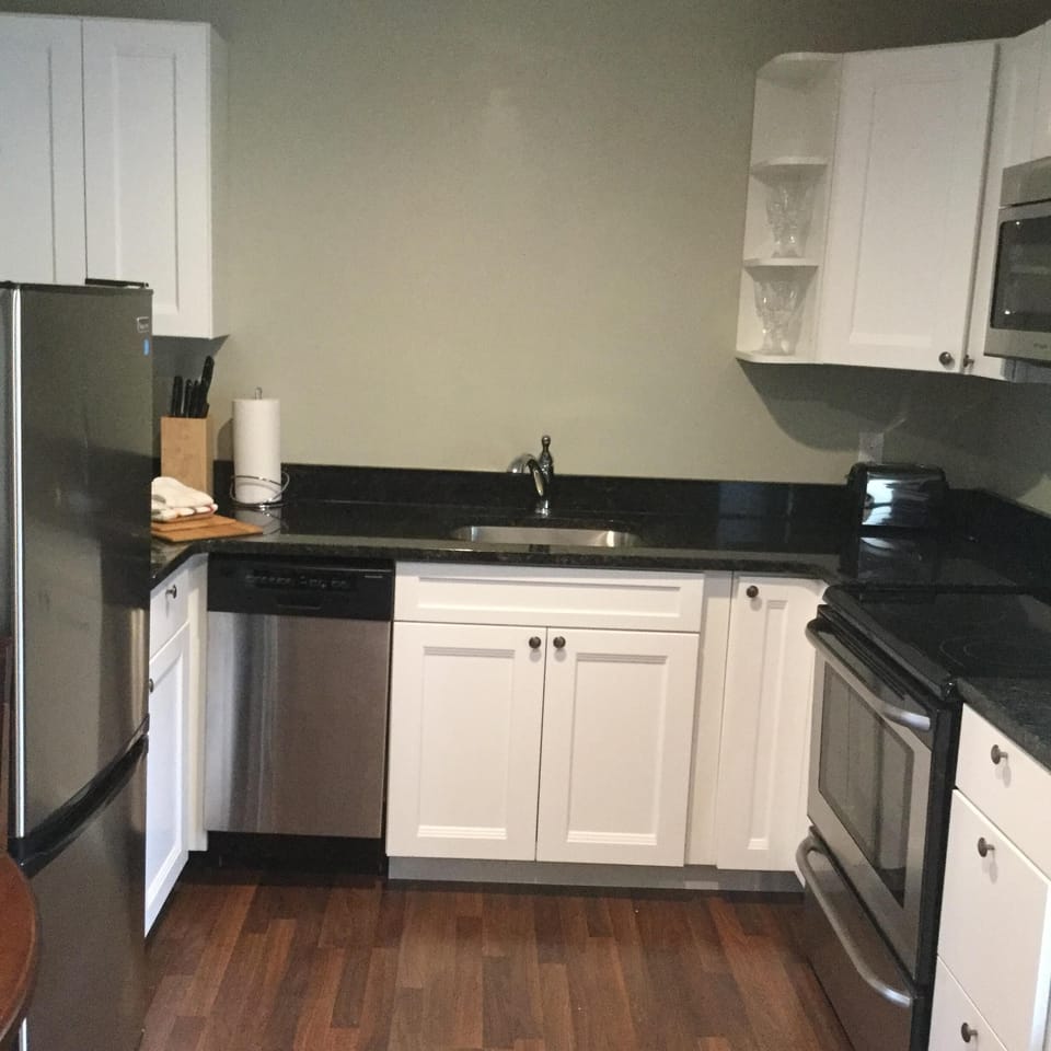 full kitchen with granite and stainless steel