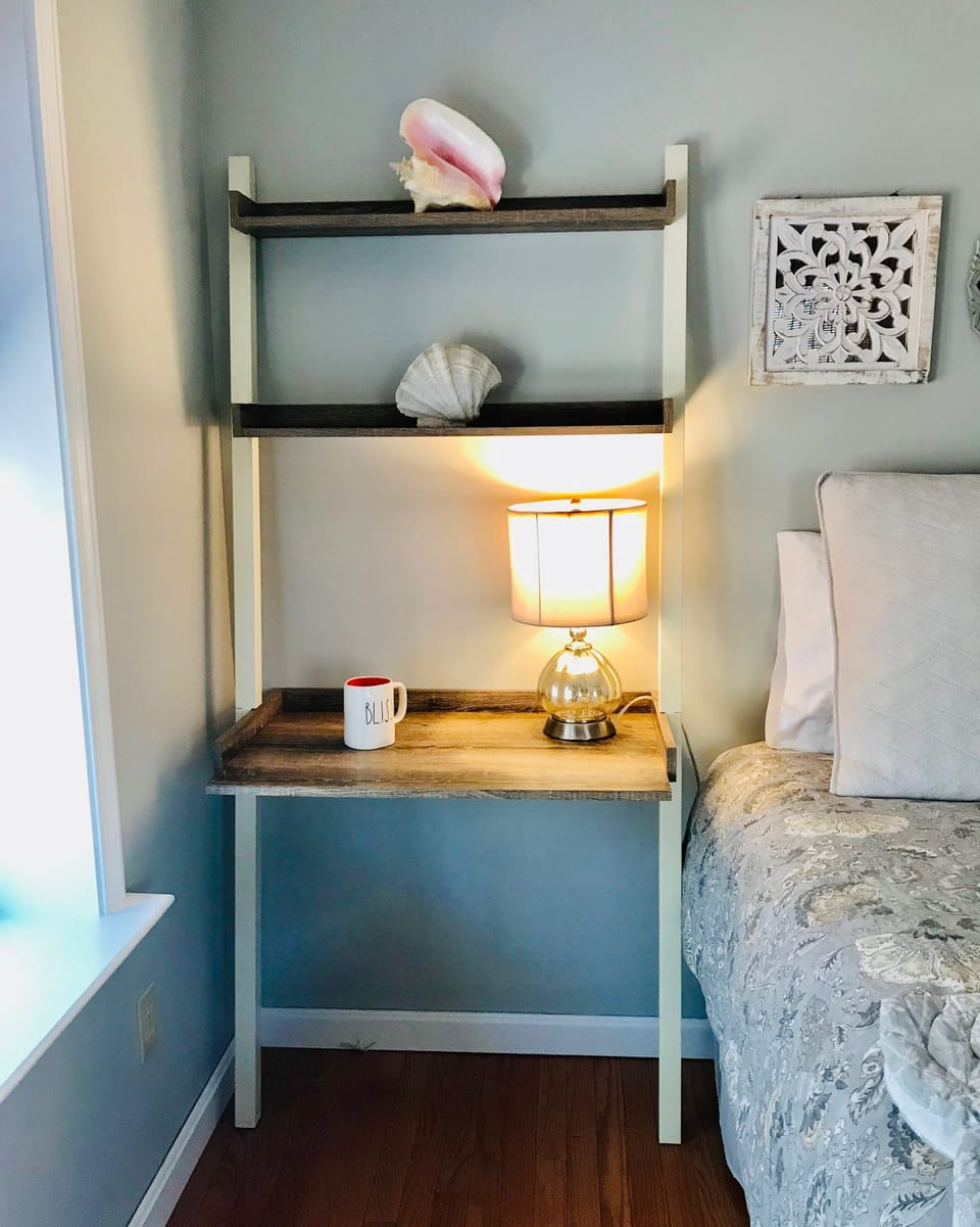 Desk in bedroom with queen bed.