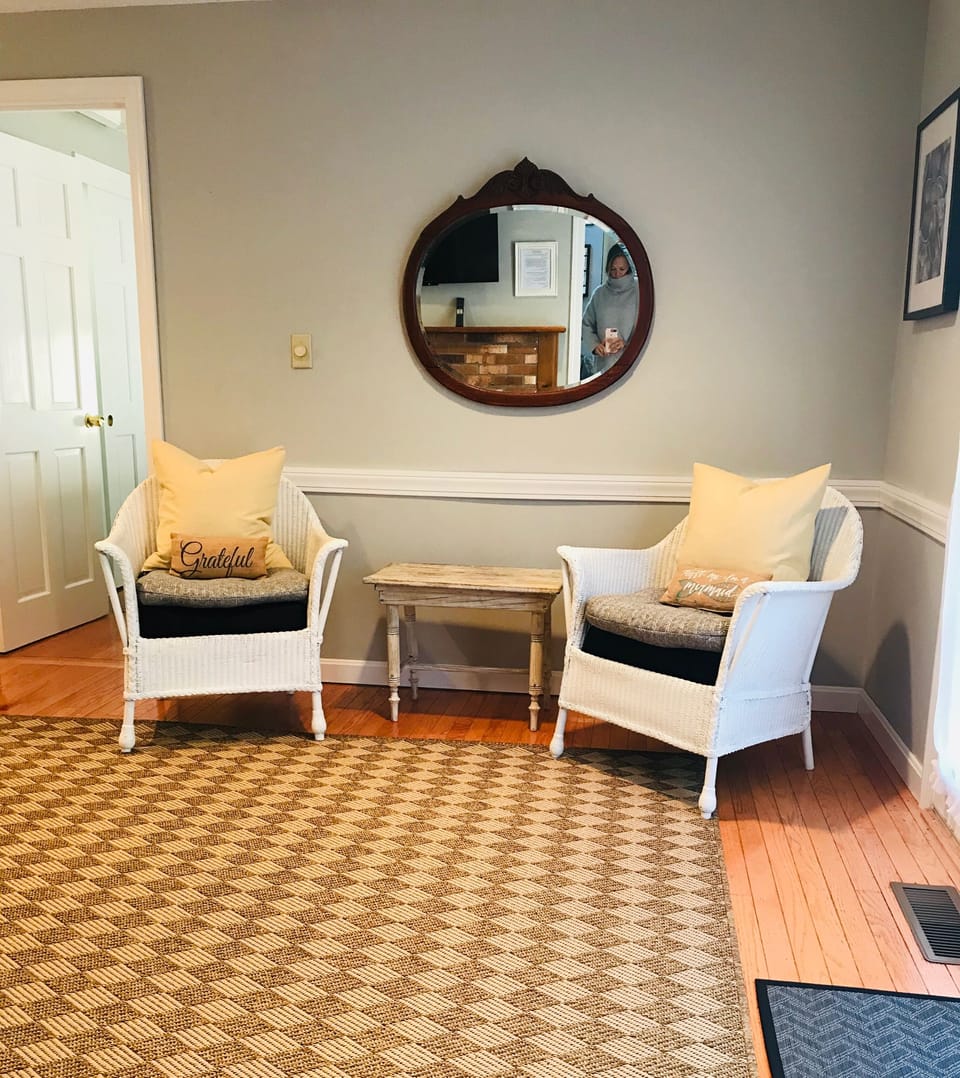 Sitting area in large room with king bed