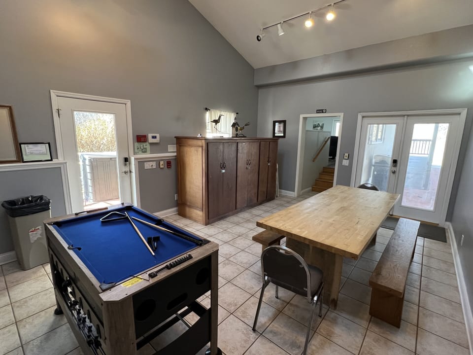 The game table in the dining room is interchangeable between foosball and mini pool.