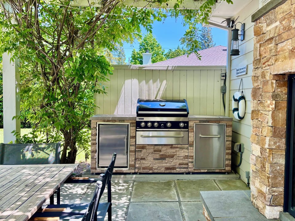 Outdoor kitchen with deluxe gas grill and refrigerator