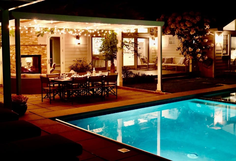 Evening outdoor entertaining under the lights, by the fireplace and at the pool