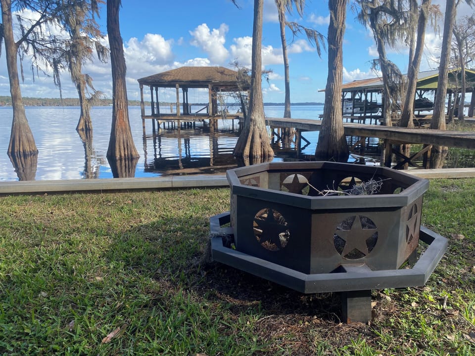 Our fire pit just feet from the seawall and Lake Louisa