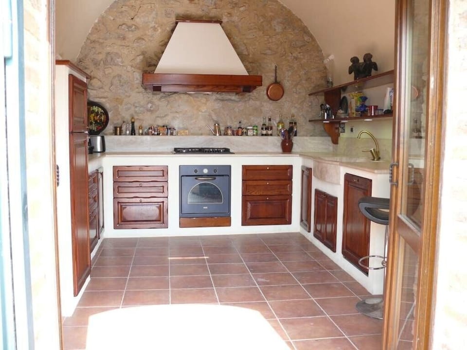 The fully equipped kitchen, including dishwasher. Laundry  room is next door. 