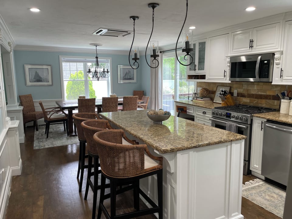Newly redecorated gourmet kitchen with live edge walnut table .