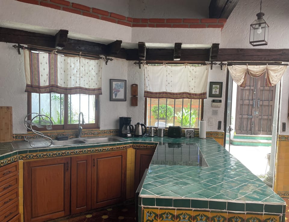 View towards the front patio.  A full size dishwasher underneath the countertop.