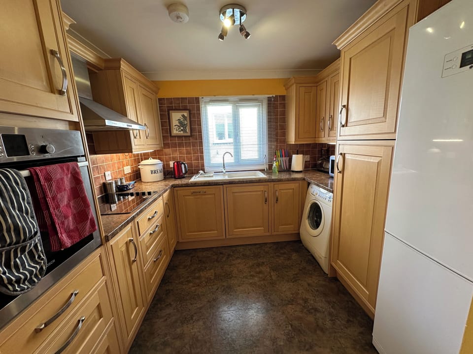 Kitchen with washing machine and large fridge / freezer