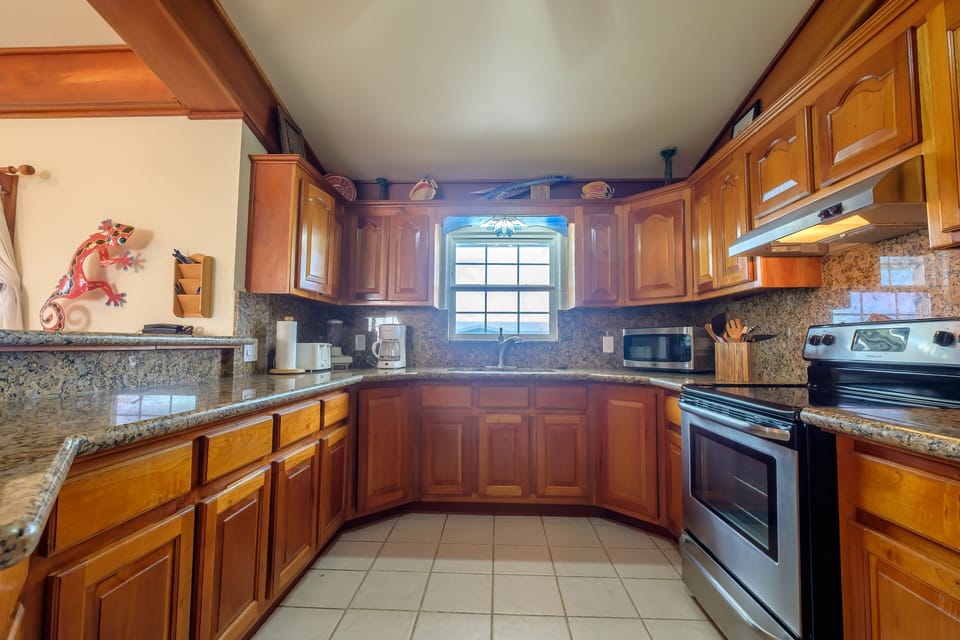 Fully equipped kitchen with granite countertops and stainless steel appliances 
