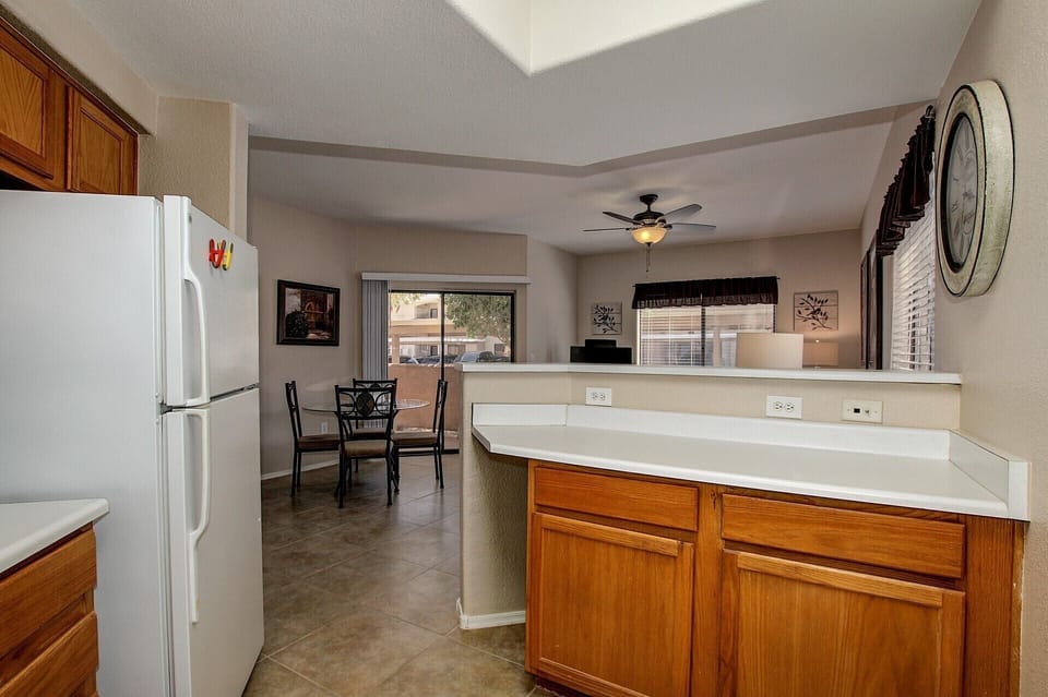 Open living room, kitchen, dining room with sliding  doors out to patio