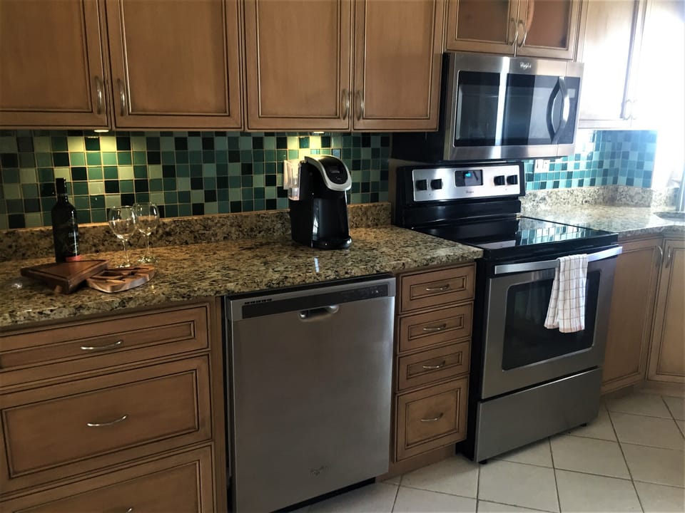 kitchen showing new stainless steel appliances, fridge not in view