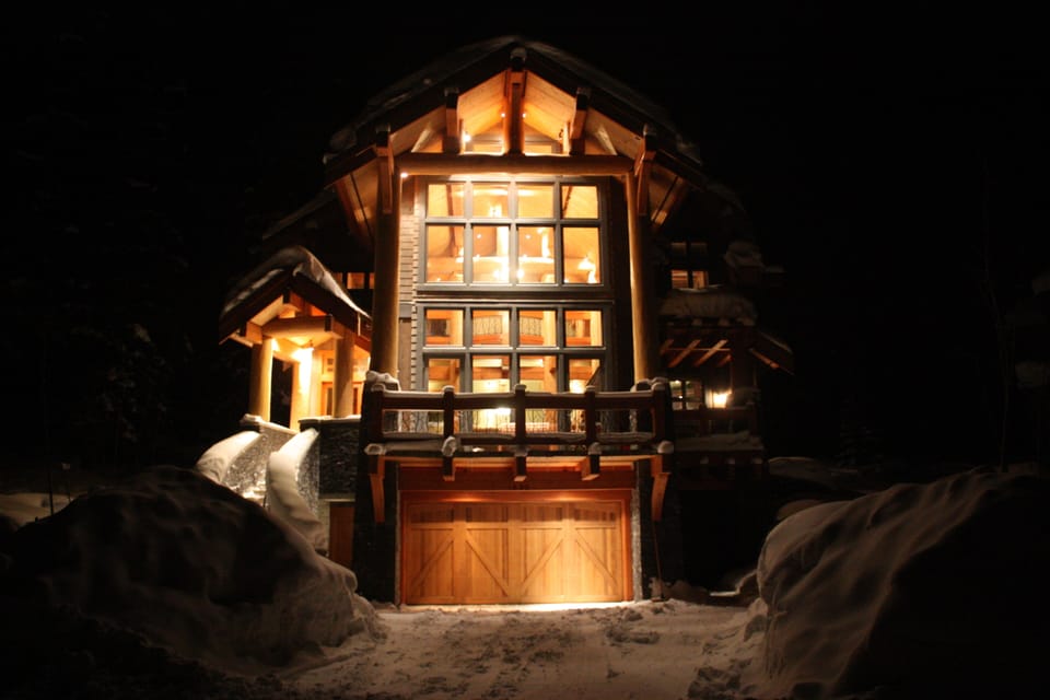 Night view into beautiful floor to ceiling windows & curved front staircase