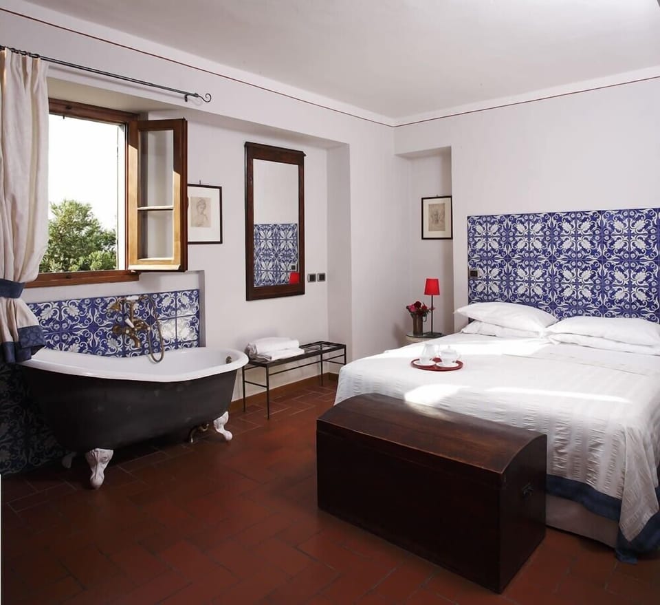 Bedroom with old white iron bath