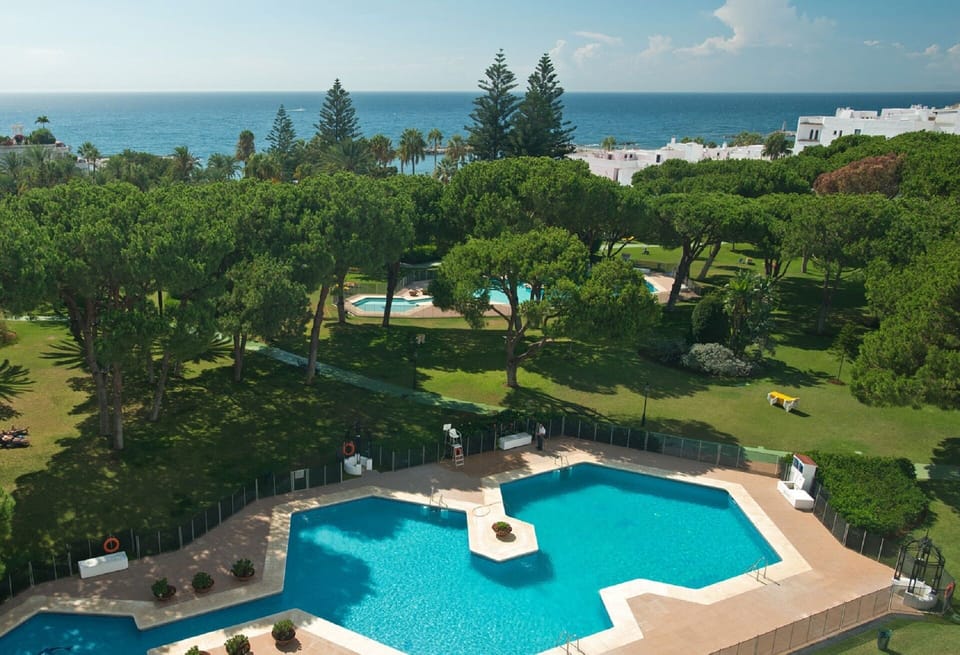 partial aerial view overlooking a pool ans the beach
