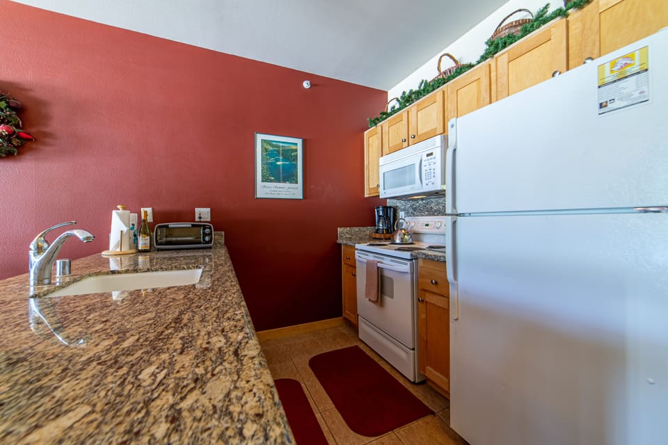 Full Kitchen with Granite Counters and everything you need to cook a meal for 4.