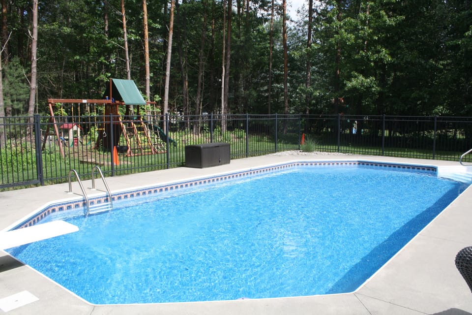 In-ground pool, tons of pool toys, backyard playground, and horseshoe pit