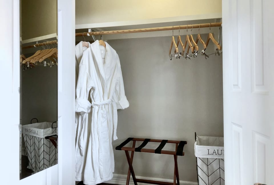 One of the guest closets. Wooden hangers and full length mirrors for dressing. White plushy bathrobes to spoil yourself