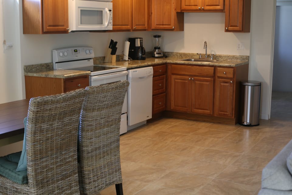 Kithen is fully stocked with modern appliances, gadgets, dishes and more.