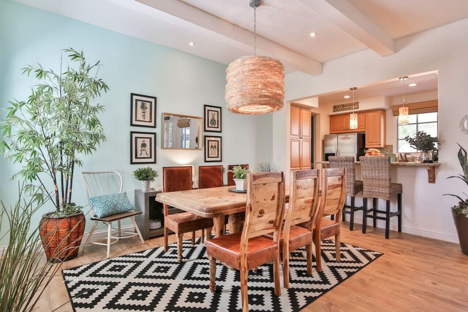 The rustic pine dining table with funky light fixture and seating for up to 8. Plus you`ll have two extra bar counter seats.