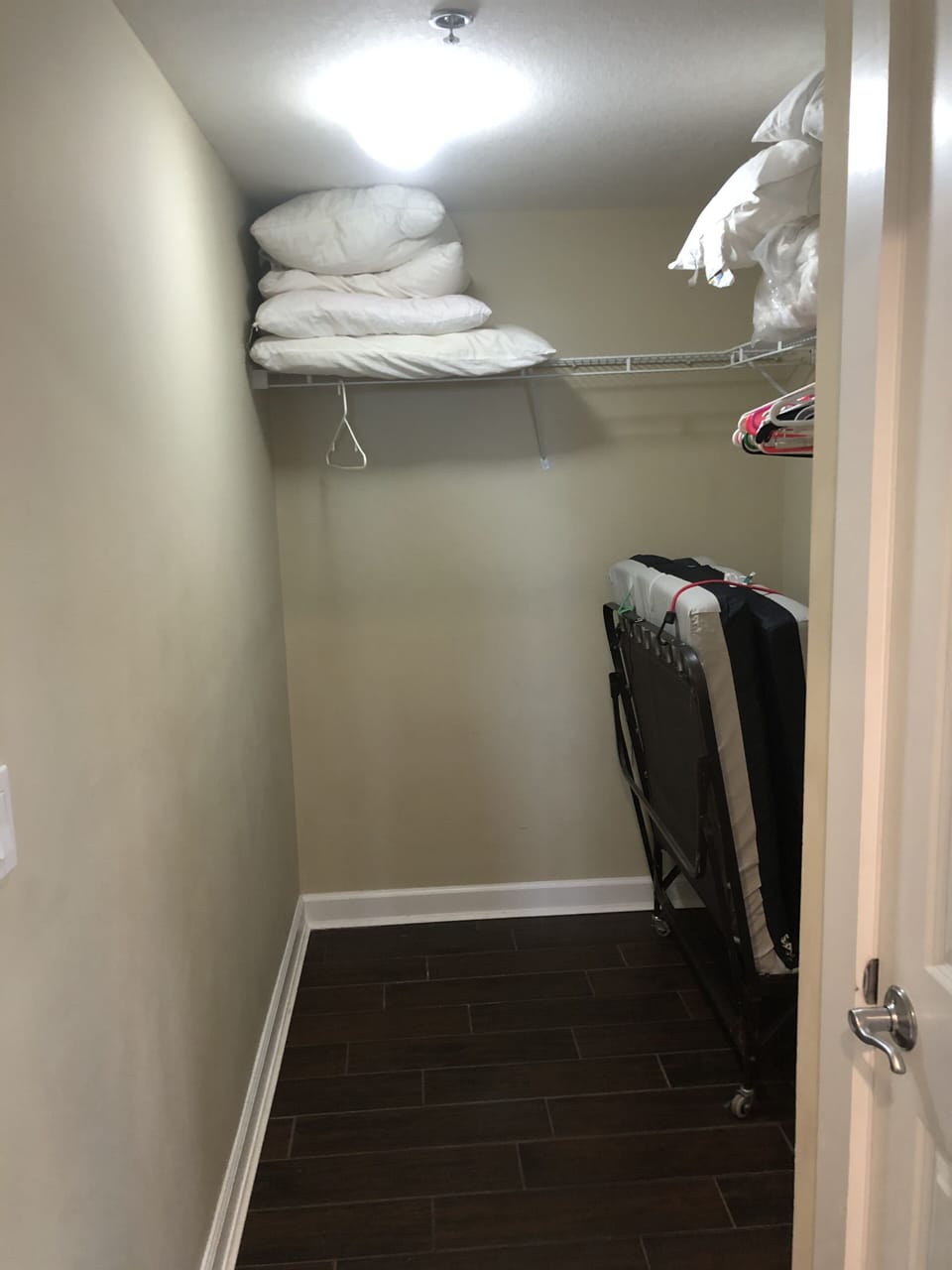 Large master closet with a rollaway bed.