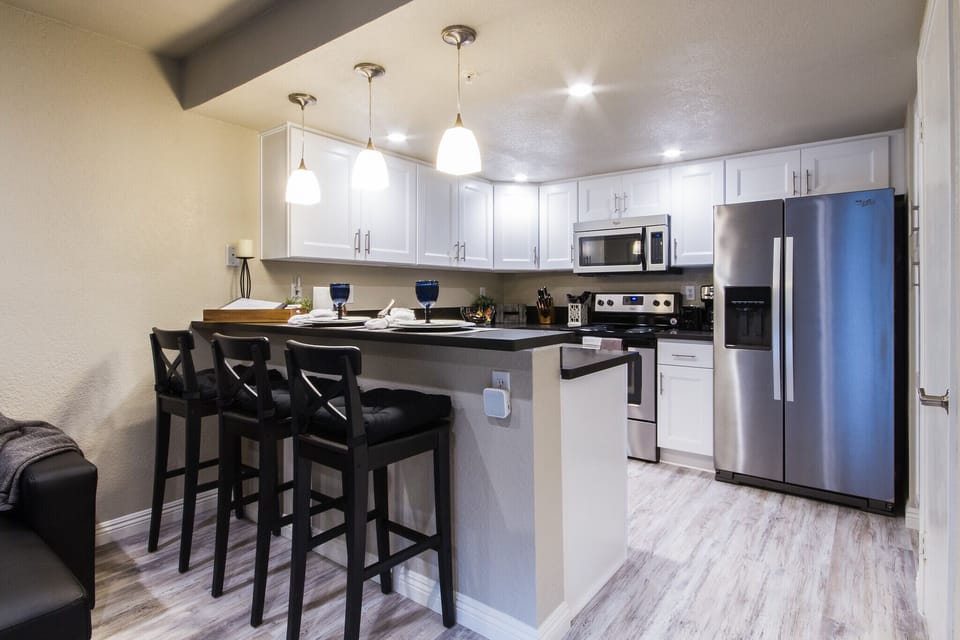 A magnificent bar and kitchen, with adjacent open plan Living Room.