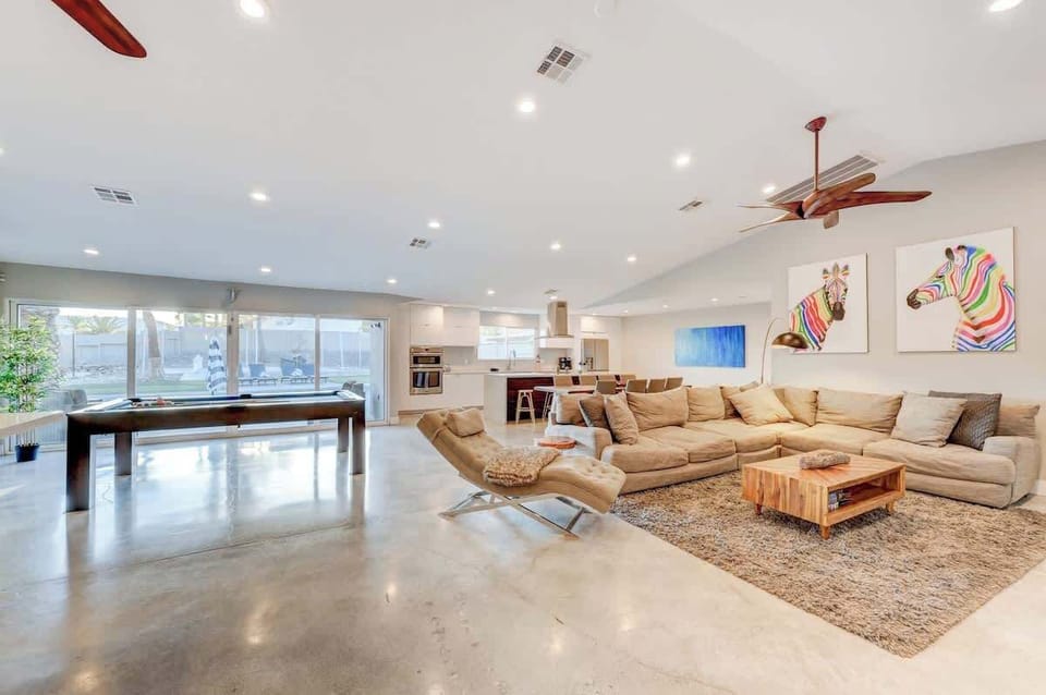 Bright open-concept living room with modern seating and Smart TV