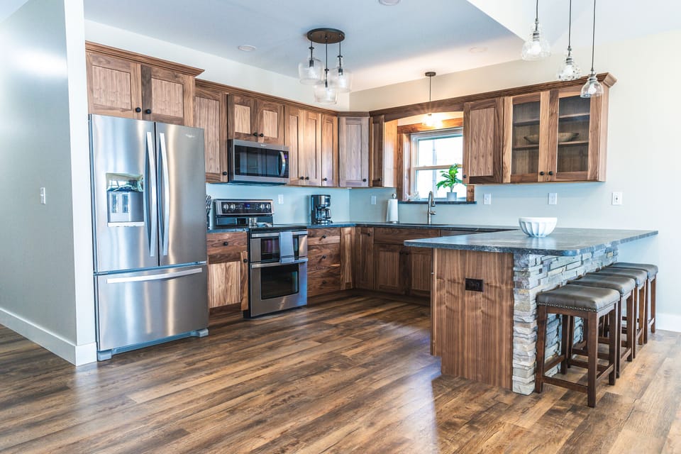 Custom black walnut kitchen with leathered granite counter.