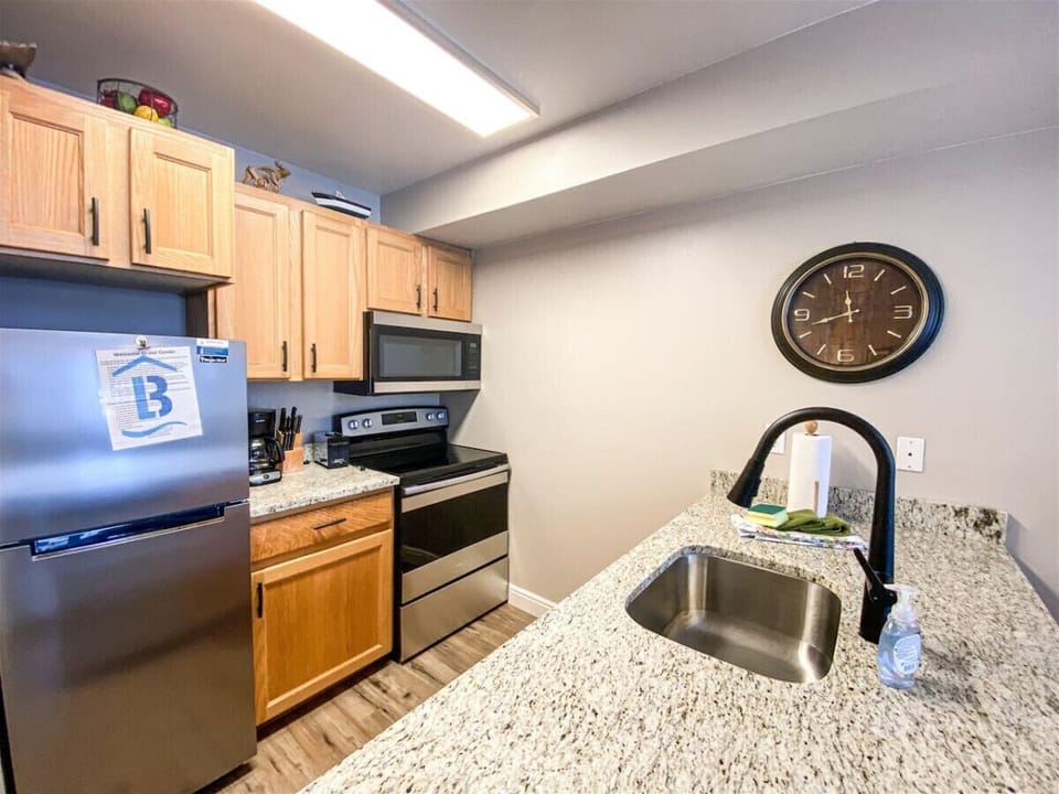 Modern granite kitchen with stainless steel appliances—fully stocked for all your cooking adventures.