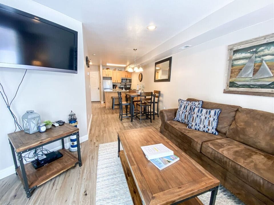 Cozy open-concept living area with nautical charm, perfect for relaxing or enjoying great company.