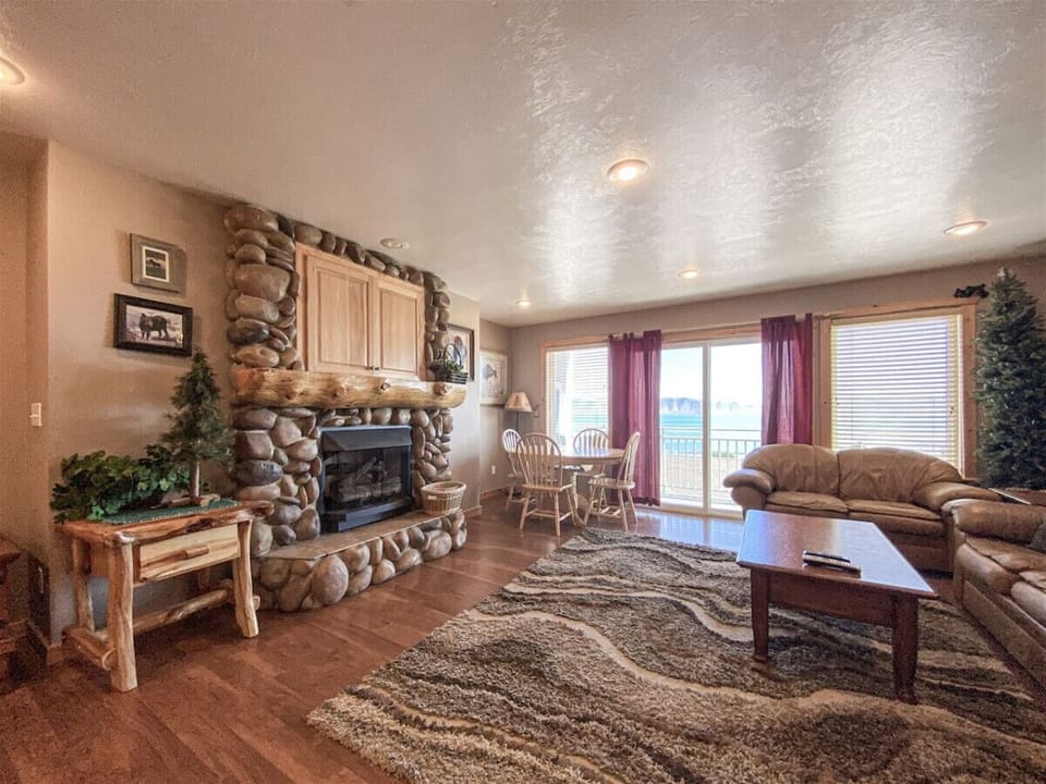 Cozy living room with stone fireplace and warm wood accents