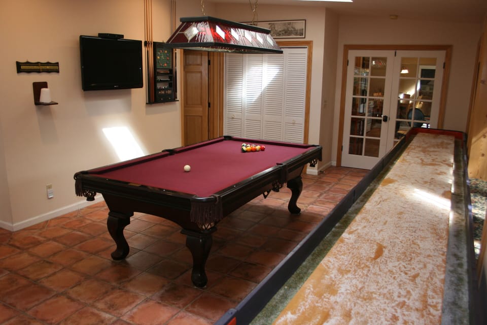 Game room with pool, shuffleboard, and flat screen TV
