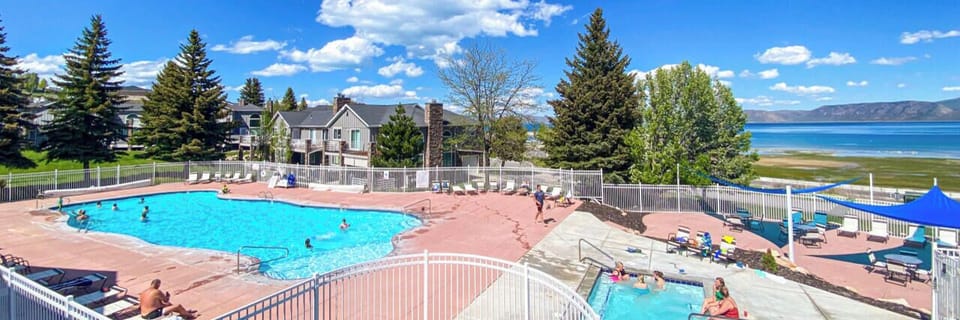 Seasonal outdoor pool and hot tub with stunning lake views, perfect for relaxing and unwinding.