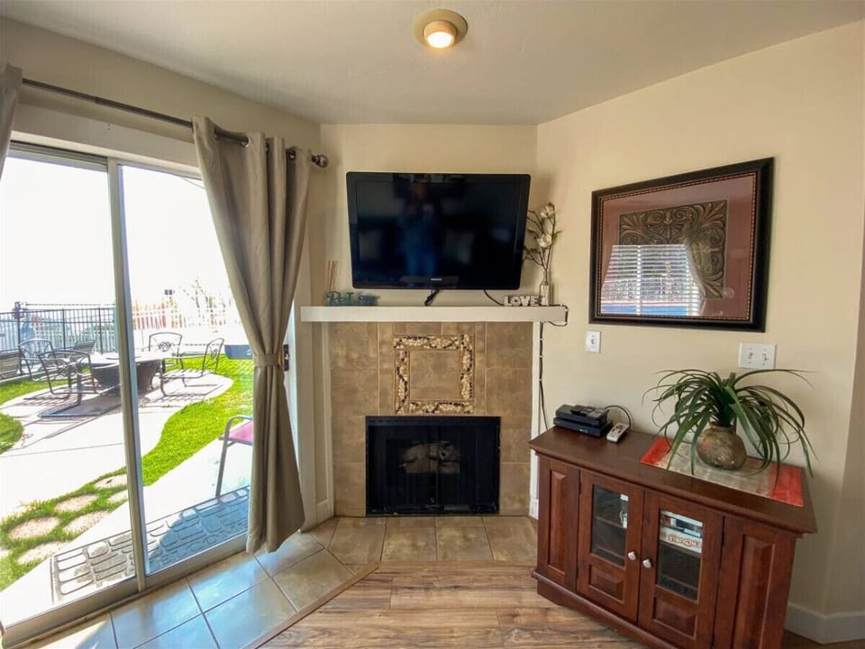 Watch TV by the cozy fireplace or enjoy the inviting patio view just steps away.